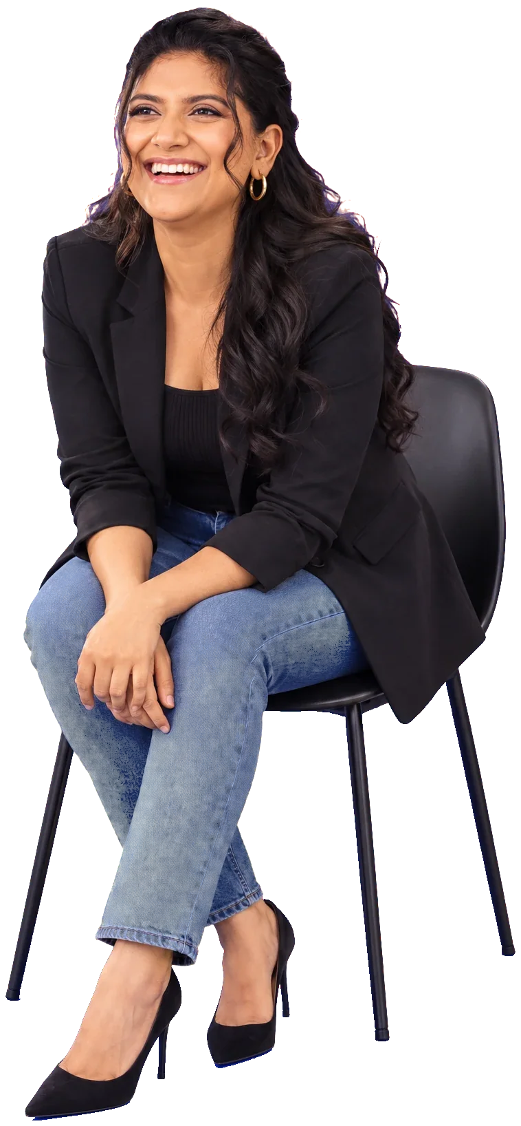 Amisha Sharma, seated and laughing